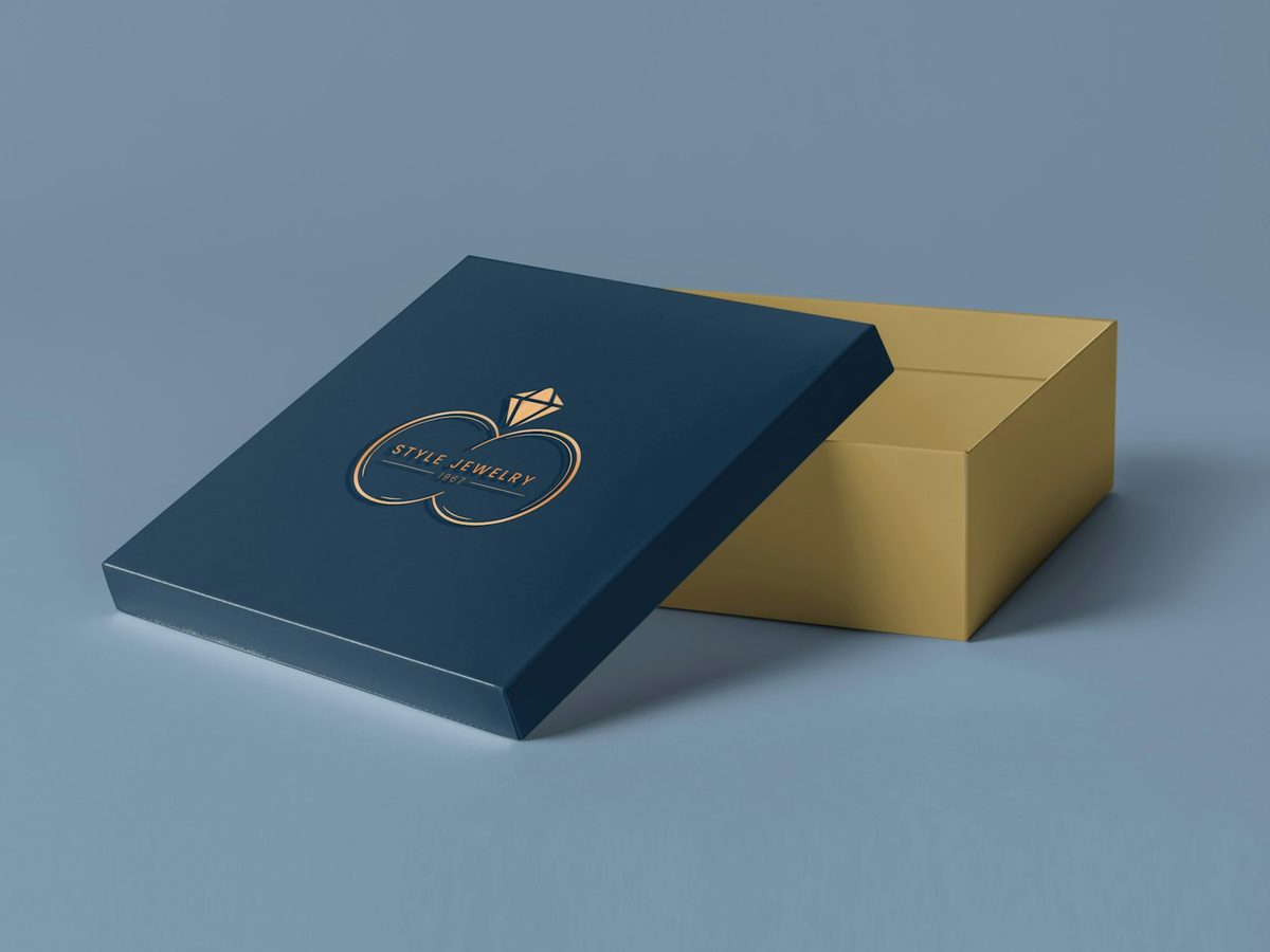 Navy rigid box with a gold foil logo